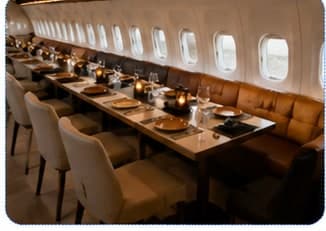 Booth seating along the windows of an aircraft restaurant cabin