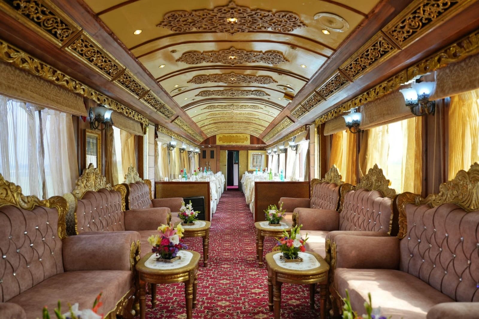 The lounge of a palace train: gilded ceiling, velvet sofas and a red carpet